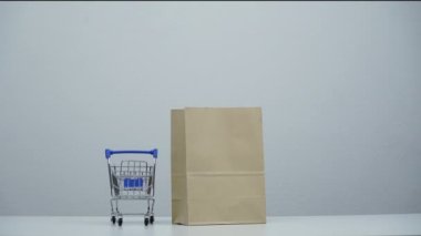 stop motion a cart shopping moving around paper bag.