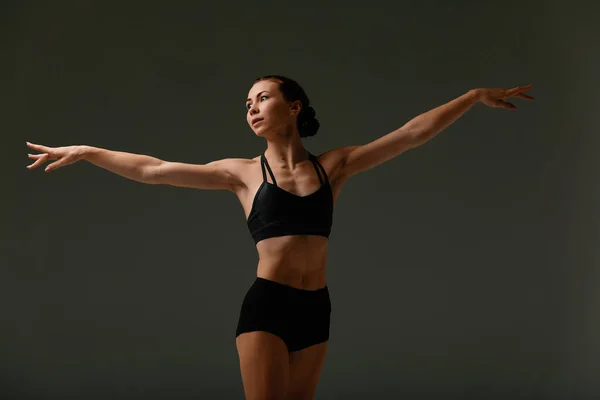 Emotional Female Ballet Dancer in Body Suit and Posing in Dance in Various Poses Against Gray Background — Stock Photo, Image