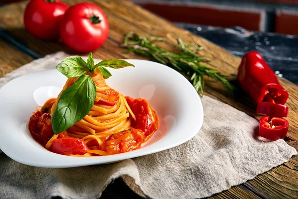 Spaghetti tomatoes basil on wooden background — Stock Photo, Image