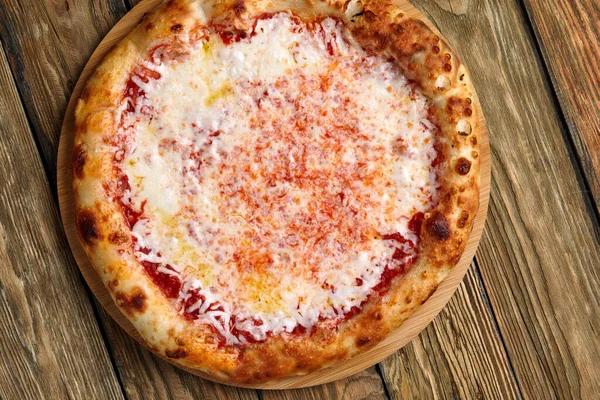 Pizza Margherita sobre fondo de madera, vista superior. Folleto y póster de Restaurantes o pizzerías, plantilla con delicioso sabor a pizza margarita, queso mozzarella — Foto de Stock