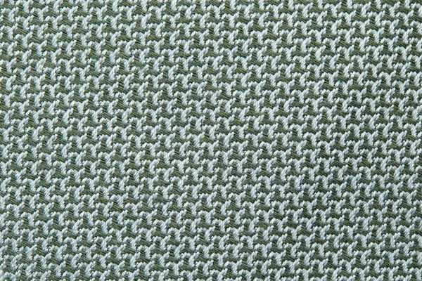 Struttura lavorata a maglia. Texture in tessuto jacquard con motivo geometrico grigio blu. Uncinetto modello mosaico. — Foto Stock