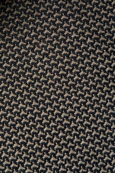 Knitted texture. Texture of jacquard fabric with gray geometric pattern. Crochet mosaic pattern