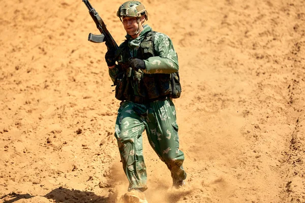 Soldiers game on military training ground, battle camp. Action. Operation Trainer giving training to military soldiers at boot camp.