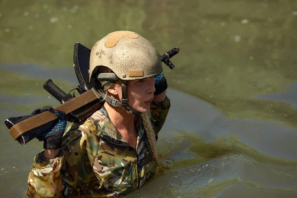 Full military experience - One day commando - running through the water with automatic rifle replica.