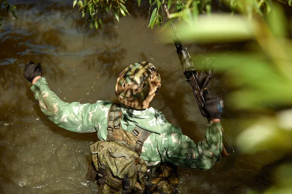 Full military experience - One day commando - running through the water with automatic rifle replica.