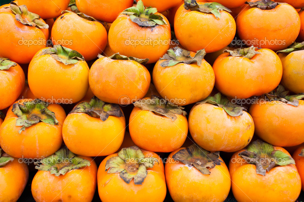 Persimmon fruit background — Stock Photo © comzeal #12732036