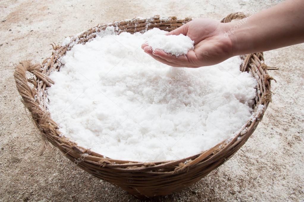hand with salt in basket