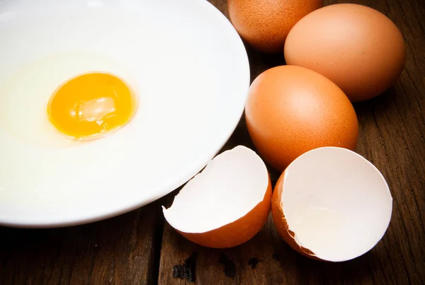 Broken chicken eggs and egg yolk — Stock Photo, Image