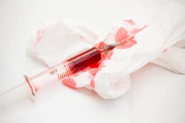 Syringes and bloody paper — Stock Photo, Image