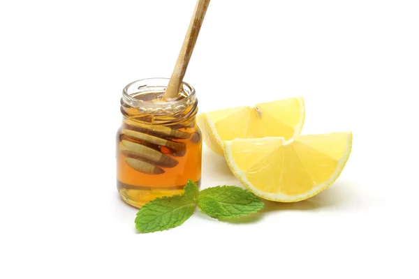 Miele e limone su sfondo bianco — Foto Stock