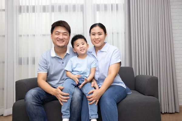 Happy Asian Family Little Son Sitting Sofa Together Home — стокове фото