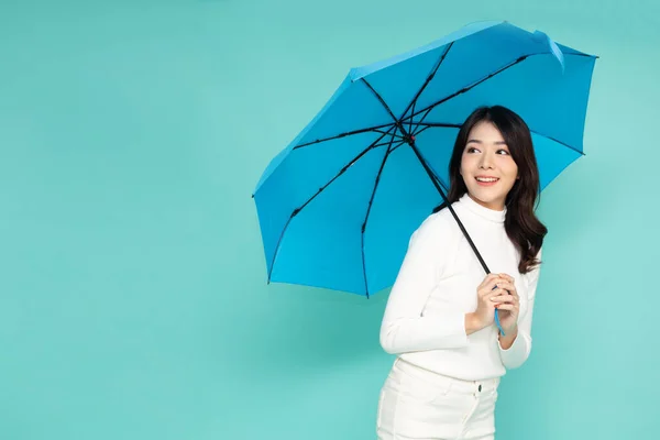 Young Asian Woman Holding Blue Umbella Standing Isolated Green Background — 스톡 사진