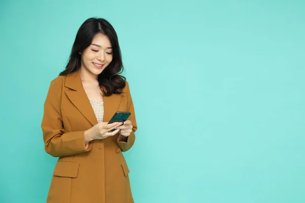 Happy Young Asian Business Woman Using Mobile Phone Isolated Green —  Fotos de Stock