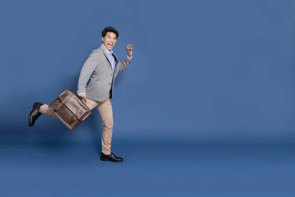 Smiling Young Asian Businessman Showing Credit Card Holding Brown Bag — Fotografia de Stock