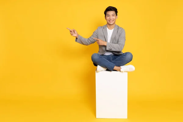 Smiling Young Asian Businessman Pointing Empty Copy Space Sitting White — Stock Photo, Image