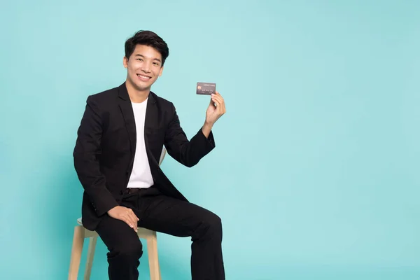 Asian Businessman Sitting Showing Credit Card Making Payment Isolated Green —  Fotos de Stock