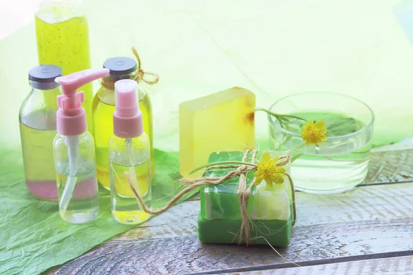 Natural soap, disinfectant spray, oils, tinctures and flowers of celandine on a wooden windowsill, the concept of cleanliness, healthy lifestyle, body care