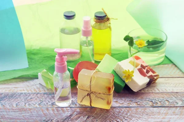 Natural soap, disinfectant spray, oils, tinctures and flowers of celandine on a wooden windowsill, the concept of cleanliness, healthy lifestyle, body care