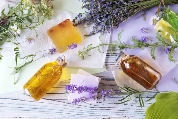 Lavender flowers, soap, oils and tinctures, on a wooden background, natural ingredients, alternative medicine