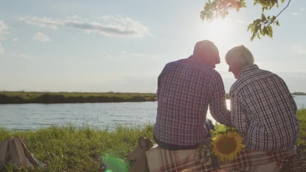 Happy Elder Affectionate Grandfather Grandmother Together Sitting Lake Beach Holding — Stockvideo