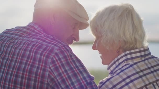 Happy Affectionate Elderly Grandparents Together Hugging Sitting Lake Beach Date — Stockvideo