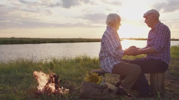 Happy Smiling Older Couple Embrace Talks Sitting Together Lake Beach — Stockvideo