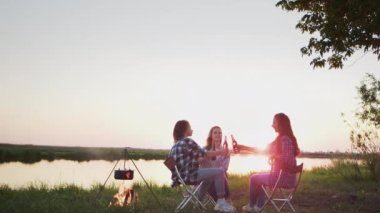 Group of woman friends enjoy party drinking champagne together while boat sailing at summer sunset. Male and female relax outdoor lifestyle on sail yacht tropical travel vacation, calm mind, relax