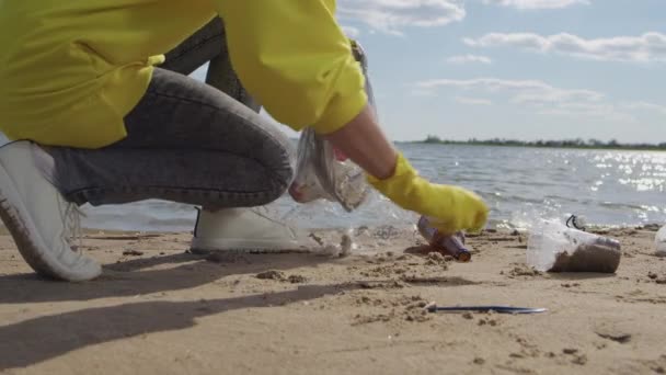 Young Woman Takes Care Environment Picking Trash Lying Wet Sand — Stock video