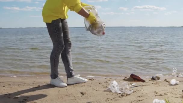 Young Woman Takes Care Environment Picking Trash Lying Wet Sand — Video