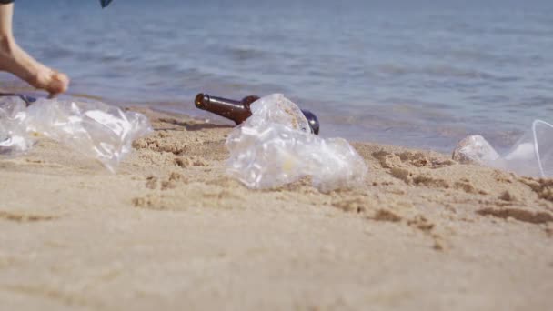 Female Environmentalist Picks Glass Bottle Plastic Bags Scattered Wet Sand — Vídeos de Stock