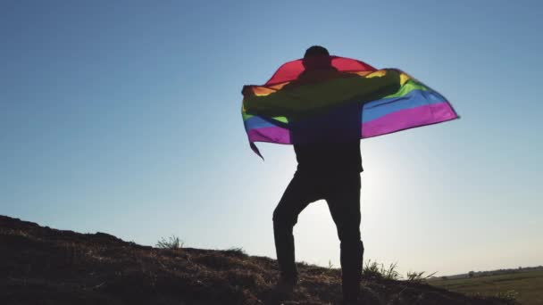 Young Man Goes Uphill Wild Area Covered Rainbow Lgbt Flag — Stok Video