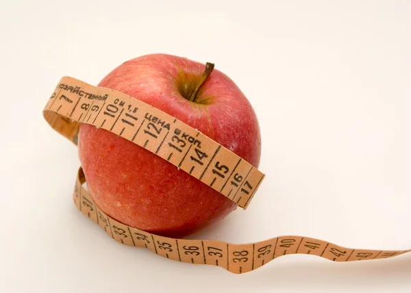 Red apple with measuring tape — Stock Photo, Image