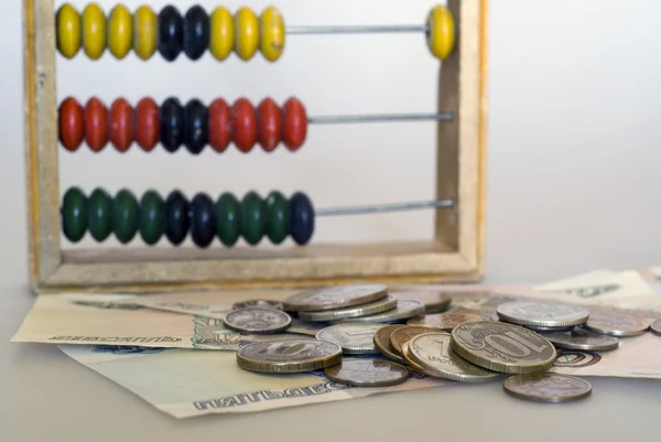 Abacus and money — Stock Photo, Image