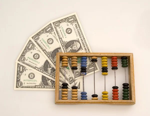 Abacus and dollars — Stock Photo, Image