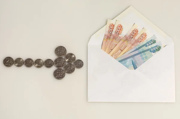 Coins arrow points to envelope with money — Stock Photo, Image