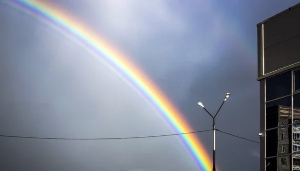 Rainbow in the nasty city sky — Stock Photo, Image