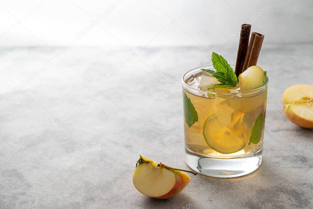Iced apple juice iced spritzer refreshing drink with mint and fresh apple. Lifestyle juice