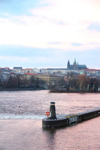 Beacon on the Vltava river against old Prague view — Stock Photo, Image