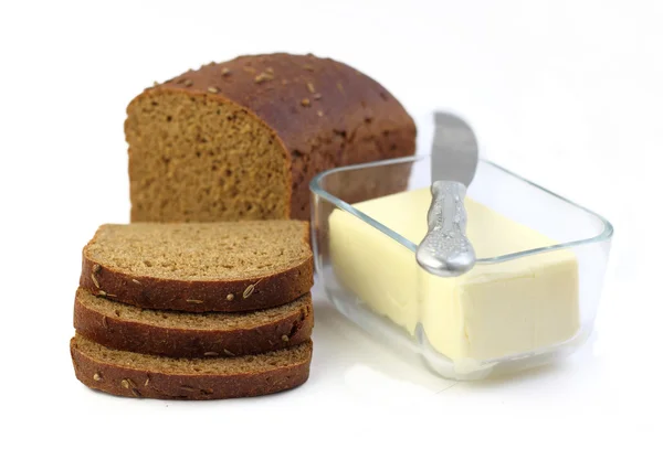 スライスとガラス容器にバターとライ麦パンのパン — ストック写真