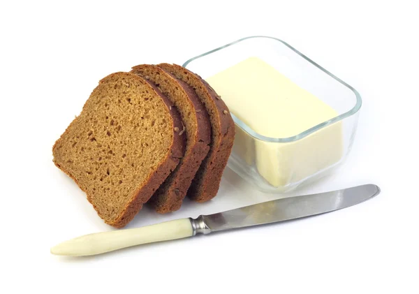 ライ麦パンとバター、ガラス容器のスライス — ストック写真