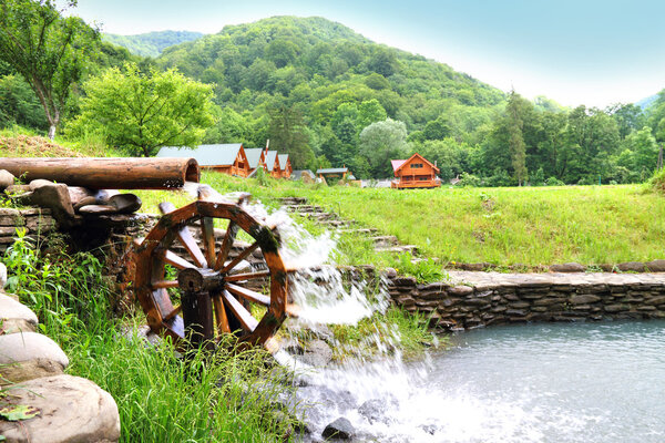 Stream with wooden water wheel in the Carpathians