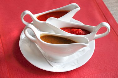 Three sauces - adjika, tkemali and satsebeli clipart