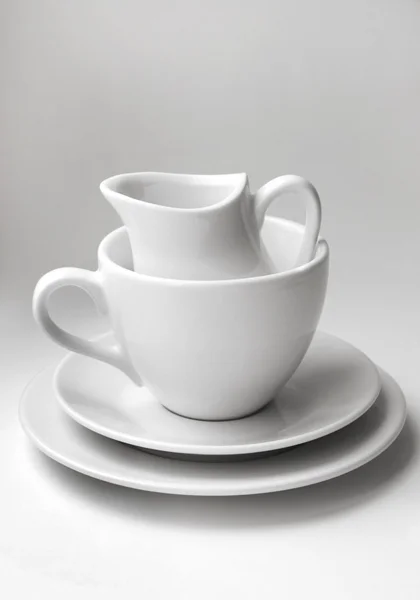 Stack of different clean white crockery — Stock Photo, Image