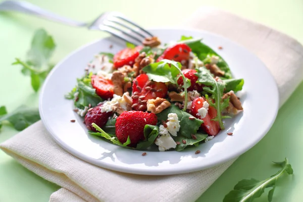Salade met rucola, aardbeien, geitenkaas en walnoten Stockfoto
