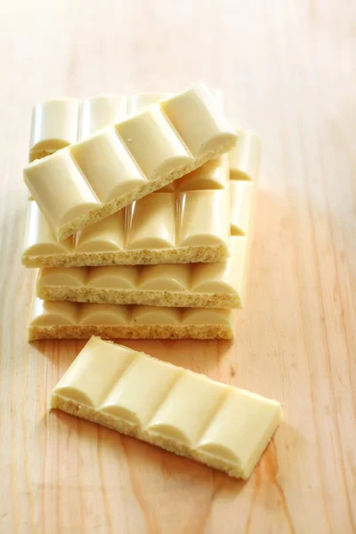 White porous chocolate on wooden background — Stock Photo, Image