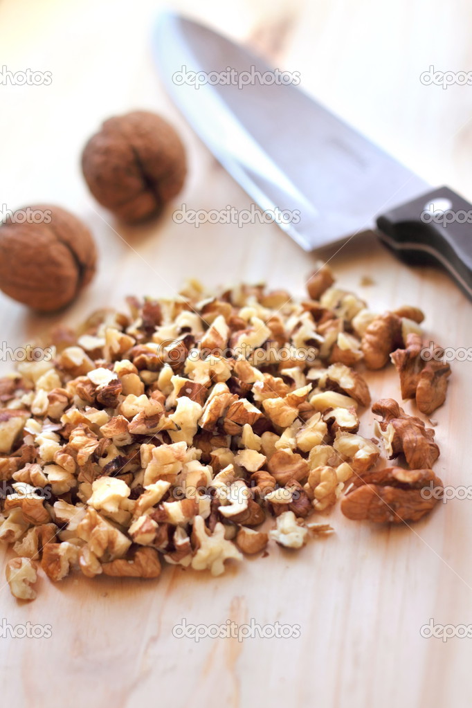 Chopped walnuts on wooden background