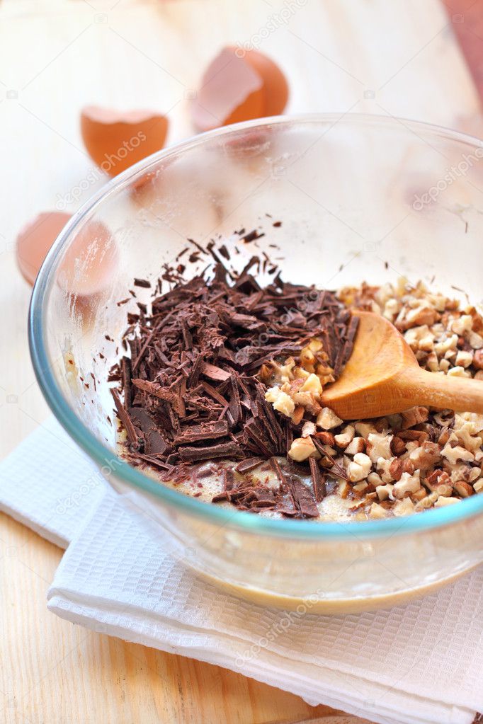 Chopped chocolate and walnuts in glass bowl