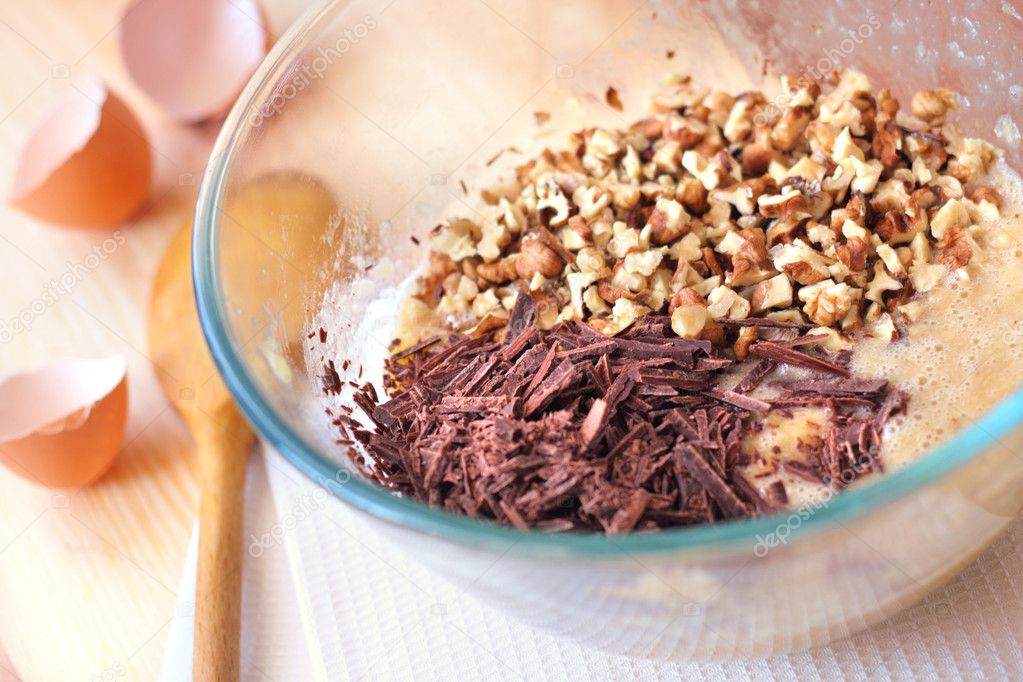 Chopped chocolate and walnuts in glass bowl