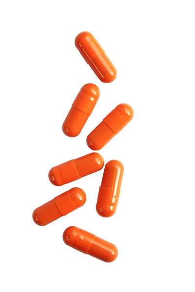 Capsules de pilule orange isolées sur fond blanc Photos De Stock Libres De Droits