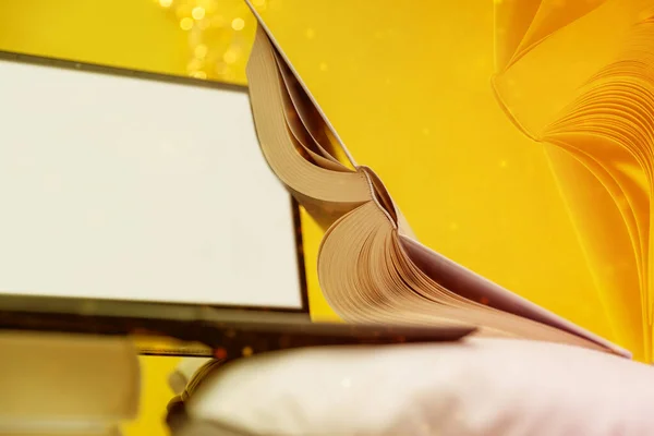 Concept of online learning and working remotely with open books in yellow colors, new normal lifestyle